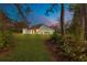 Expansive backyard featuring a well-maintained lawn and rear view of the home with patio seating at 30041 Redoak Ave, Eustis, FL 32736