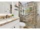 Updated bathroom featuring granite countertops, floating shelves, and a glass shower at 30041 Redoak Ave, Eustis, FL 32736