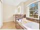 Bright bathroom featuring a soaking tub with a view of the outdoors at 30041 Redoak Ave, Eustis, FL 32736