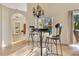 Bright breakfast nook featuring tile floors, arched doorway and a charming chandelier, creating an inviting space at 30041 Redoak Ave, Eustis, FL 32736