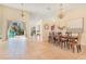 Open floor plan with dining area, patio access, tile floors, and backyard views at 30041 Redoak Ave, Eustis, FL 32736