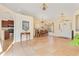 Open concept dining room with chandeliers, tile floor, and access to kitchen and entry at 30041 Redoak Ave, Eustis, FL 32736