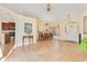 Spacious dining room adjacent to kitchen and foyer, boasting tile floors and chandelier at 30041 Redoak Ave, Eustis, FL 32736