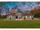Charming single-story home featuring a manicured lawn and a striking blue front door at 30041 Redoak Ave, Eustis, FL 32736