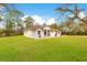 Charming single-story home with a well-manicured lawn, lovely landscaping, and a welcoming front patio at 30041 Redoak Ave, Eustis, FL 32736