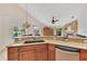 Open kitchen with granite counters and view of fireplace and outdoor scenery at 30041 Redoak Ave, Eustis, FL 32736