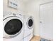 This laundry room features a washer, dryer, a door, and tile floors at 30041 Redoak Ave, Eustis, FL 32736