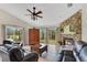 Cozy living room featuring a stone fireplace, comfortable seating, and natural light at 30041 Redoak Ave, Eustis, FL 32736