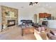 Open-concept living room with fireplace, and view of kitchen and dining areas at 30041 Redoak Ave, Eustis, FL 32736