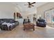 Open-concept living room with a stone fireplace and tile floors, perfect for entertaining and relaxing in style at 30041 Redoak Ave, Eustis, FL 32736