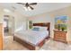 Serene main bedroom featuring a king-size bed, natural light, and ensuite bathroom at 30041 Redoak Ave, Eustis, FL 32736