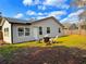 Lush backyard featuring three wooden chairs, perfect for relaxing in a tranquil setting at 3106 Garden Ct, St Cloud, FL 34769