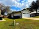 An image showcases a home's backyard with a well-maintained lawn and a one-car garage at 3106 Garden Ct, St Cloud, FL 34769