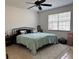 Bright bedroom featuring a comfortable bed with a ceiling fan and natural light at 3106 Garden Ct, St Cloud, FL 34769