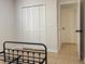 This bedroom offers ample storage with a bi-fold door closet and beige tiled flooring at 3106 Garden Ct, St Cloud, FL 34769