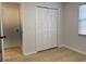 Bright room showcases a bi-fold door closet and an adjacent doorway with beige tiled flooring at 3106 Garden Ct, St Cloud, FL 34769