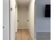 Hallway with neutral walls and floors leading to bedrooms and living areas at 3106 Garden Ct, St Cloud, FL 34769