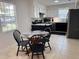 Cozy dining area featuring a round table and a view of the kitchen with black appliances at 3106 Garden Ct, St Cloud, FL 34769