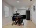 Bright kitchen and dining area with tile floors, black appliances and a wooden dining table at 3106 Garden Ct, St Cloud, FL 34769