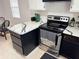 Spacious kitchen features stainless steel appliances, black cabinets and white marbled countertops at 3106 Garden Ct, St Cloud, FL 34769