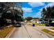 A cozy neighborhood street featuring well-maintained homes with landscaped yards and tree-lined sidewalks at 3106 Garden Ct, St Cloud, FL 34769