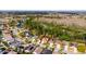 Aerial view of homes in a neighborhood near a wooded area and a large pond at 3121 Bellingham Dr, Orlando, FL 32825