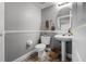 Powder room with pedestal sink, toilet, and stylish decor at 3121 Bellingham Dr, Orlando, FL 32825