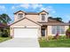 Charming two-story home with a well-manicured lawn and inviting curb appeal in a peaceful neighborhood at 3121 Bellingham Dr, Orlando, FL 32825