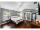 This bedroom features wood floors, a ceiling fan and ensuite bath at 3121 Bellingham Dr, Orlando, FL 32825