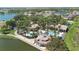 Aerial view of the community clubhouse with a pool, surrounded by palm trees, lush landscaping, and multiple buildings at 3403 Great Pond Dr, Kissimmee, FL 34746