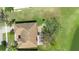 Aerial view shows the home's roof, backyard patio, and mature trees within a spacious landscaped yard at 3403 Great Pond Dr, Kissimmee, FL 34746