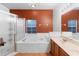 Bathroom featuring a soaking tub, a walk-in shower and double sink vanity at 3403 Great Pond Dr, Kissimmee, FL 34746