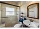 Bathroom featuring glass shower with marble tiling, framed mirror, and sink with dark wooden vanity at 3403 Great Pond Dr, Kissimmee, FL 34746