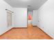 Bedroom featuring terracotta tile flooring, a window, and an ensuite bathroom at 3403 Great Pond Dr, Kissimmee, FL 34746
