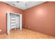 Empty closet with shelving units in a bedroom with terracotta tile flooring at 3403 Great Pond Dr, Kissimmee, FL 34746