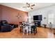 Stylish dining area with unique seating, a ceiling fan, and a nearby comfortable lounge chair at 3403 Great Pond Dr, Kissimmee, FL 34746