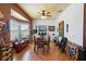 Inviting dining room featuring unique decor, a ceiling fan, and a large window with serene water views at 3403 Great Pond Dr, Kissimmee, FL 34746