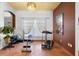 Bright exercise room with a treadmill, weights, and a large window at 3403 Great Pond Dr, Kissimmee, FL 34746