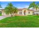 Charming single-story home with lush green lawn, palm trees, and a brick driveway at 3403 Great Pond Dr, Kissimmee, FL 34746