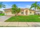 Charming single-story home with lush green lawn and well-maintained landscaping at 3403 Great Pond Dr, Kissimmee, FL 34746