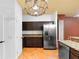 Kitchen with stainless steel refrigerator, dark cabinets, and granite countertops at 3403 Great Pond Dr, Kissimmee, FL 34746
