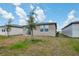 Backyard featuring unfenced yard with a partial view of a sliding glass door at 4006 Copperleaf Ln, Poinciana, FL 34759