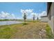 Spacious backyard features lush greenery, a scenic pond, and ample room for recreation at 4006 Copperleaf Ln, Poinciana, FL 34759