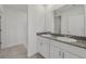 Bathroom featuring double sinks, granite countertops, and white cabinets at 4006 Copperleaf Ln, Poinciana, FL 34759