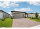 Lovely single-story home featuring a brick paver driveway, landscaping, and a well-manicured lawn at 4006 Copperleaf Ln, Poinciana, FL 34759