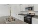 Bright kitchen features stainless steel appliances, granite counters, and a double sink at 4006 Copperleaf Ln, Poinciana, FL 34759