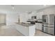 Modern kitchen featuring granite counters, stainless steel appliances, and white cabinetry at 4006 Copperleaf Ln, Poinciana, FL 34759