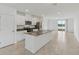 Spacious kitchen with white cabinetry, stainless appliances, island, and backyard view at 4006 Copperleaf Ln, Poinciana, FL 34759