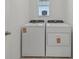 Bright laundry room with included white washer and dryer at 4006 Copperleaf Ln, Poinciana, FL 34759