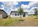 Backyard view of the house, showcasing the lawn and nearby properties at 4010 Copperleaf Ln, Poinciana, FL 34759